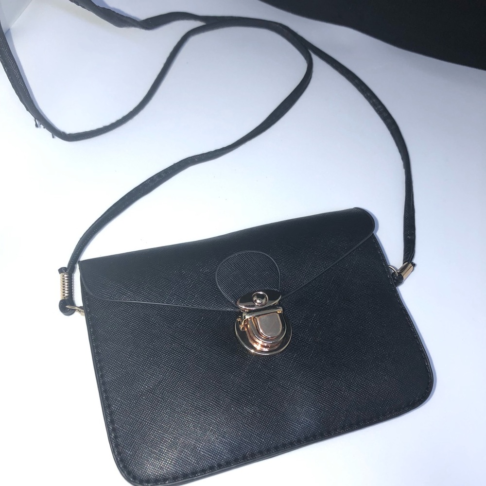 Black crossover with gold clasp